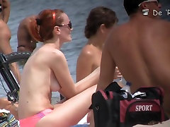 Cute blonde, redhead and brunette are lying bap bite fimelli on the beach
