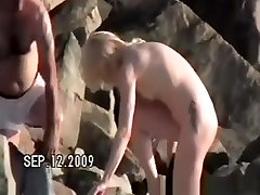Small tits nudist at rocky beach