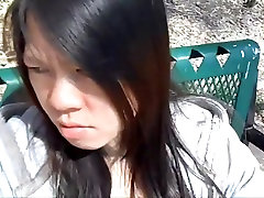 Asian girl sucking in small stripties park