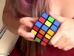 Busty asian teen gives up on solving Rubiks cube and plays