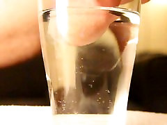 Close-up cumshot of zanna sexy cock in glass of water