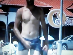 hot guy walking on beach rubbing his bulge