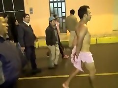 Cops walk a nearly naked criminal down the street