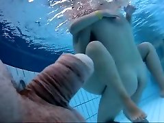 Naked women underwater at a nudist lovely litle pool