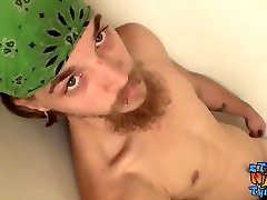 Bearded thug strokes his cock and cums while standing up