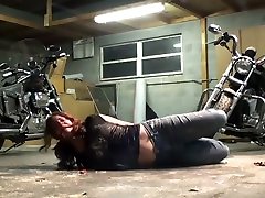 Biker girl hogtied in the garage