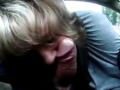 Mature wife gives good suck to man on car