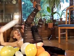 Mature model Doris Dawn plays with balloons and her hairy pussy