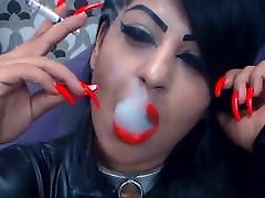 Smoking with red lips and long nails