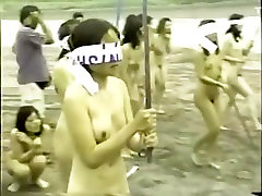 japanese heair cut girls splitting a watermelon with a stick while blindfolded