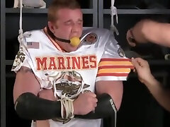 Tall redheaded football player bound gagged and stripped.