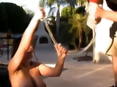 Aria Giovanni takes a beer bong on the pool