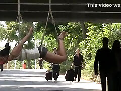 Hottie suspended from a bridge in public