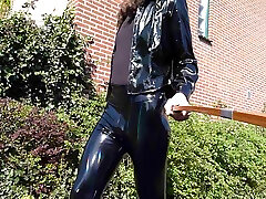 walking in the sun in black shiny outfit