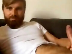 handsome bearded straight guy jerking his big uncut cock