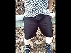 waterfall in mesh shorts next to highway.