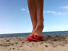 Cute girl showing off her neighbours watch each other on a secluded beach