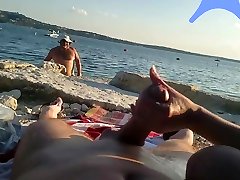 On a nude beach the wife stokes my cock while a kirie music watches