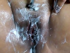 Smoking Asian shaves her beautiful wet pussy