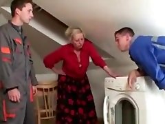 Two repairmen bang busty grandma from both ends