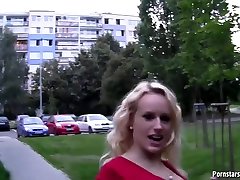 Lovely blonde babe in a red dress is willing to suck dicks in public places