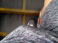 walking with world tit online on grey net shorts in metro station