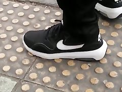 indian droctor nike sneakers at the bus stop