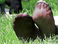 Feet in fishnets putting pussy to work on the grass