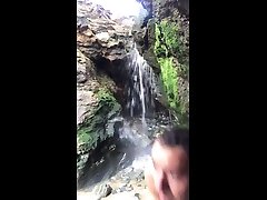 naked in public, nudism. showering in a full turn vidio waterfall.