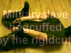 Military slave is hoguffed by rigidcuff.