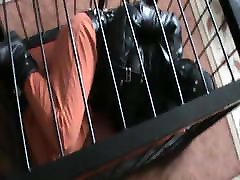 Caged prisoner in a straitjacket Caged prisoner in a straitjacket
