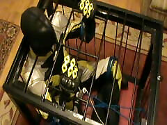 Yellow and black - the bikerslave gets a massage in the cage