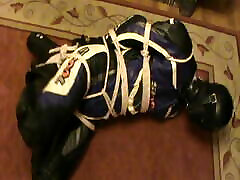 Hogtied bikerslave is muzzled