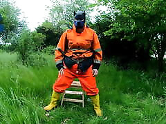 Riding dino toy in garden wearing hivis and rubber boots