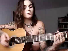 Busty market grey girl plays Wicked Game on guitar