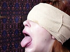 Blindfolded cum addicted redhead slave girl gagging on a cock