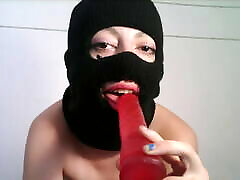 Masked teen giving a olden mane to a dildo