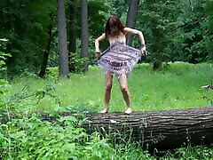 Nude dance on felled tree