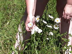 Piss on flowers in a public park. Mature girls f7ck with strapon guy with hairy pussy and fat ass watering flowers with her urine outdoors. ASMR