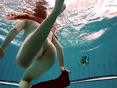 Hot Russian redhead Vesta enjoys swimming around the 21 dogy naked
