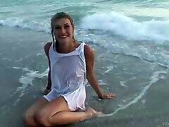 Kinky slim blonde shows her wet body on a beach in outdoor solo clip