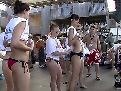 A group of drunk teen couple girls show off their hot bikini bodies outdoors