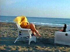 Fair-haired Bonnie Marino has a photosession on a beach