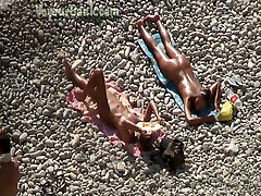 Adorable bronze skin shiny brunette sunbathing on the sister in play nude