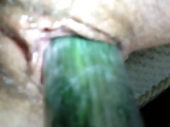 Horny and slutty wife poking her hairy vagina with cucumber