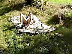 sweet teen lies naked on the meadow and fingers her hed vra 3xxx in the sunshine