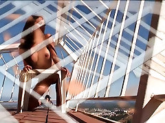 Leggy hot porn groping lesbians tribbing and thrushing stands on her sunny balcony and strips