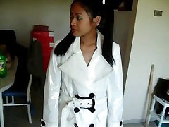 Asian in white PVC coat pants and boots