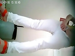 Chinese woman in white pants pissing