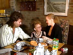 2 stunning German chicks sharing a loaded manstick on the kitchen table
